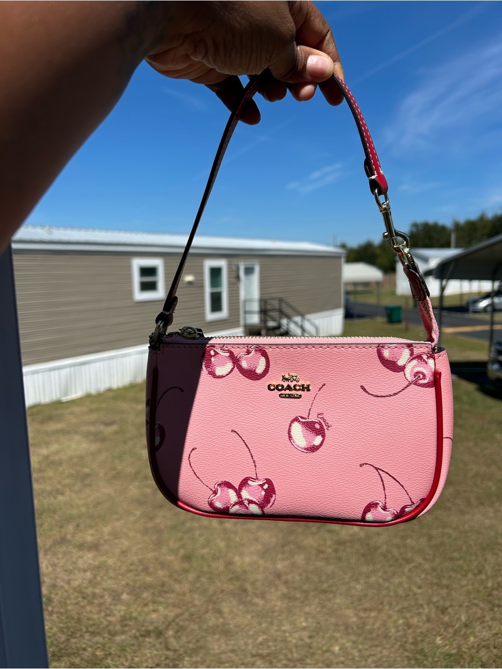 Coach Pink Cherry Print Wristlet with Gold Hardware- gently used